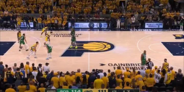 Basketball game with Boston 114 and Indiana 111, 1.7 seconds remaining in the fourth quarter at Gainbridge Fieldhouse. The crowd in yellow shirts watches intensely as the Boston Celtics and Indiana Pacers battle it out, evoking an Eastern Conference Finals atmosphere.