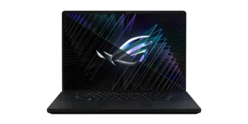 A black ASUS ROG Zephyrus G16 laptop displaying a vibrant geometric pattern with a logo in the center on its screen, perfect for performance reviews and benchmarks.