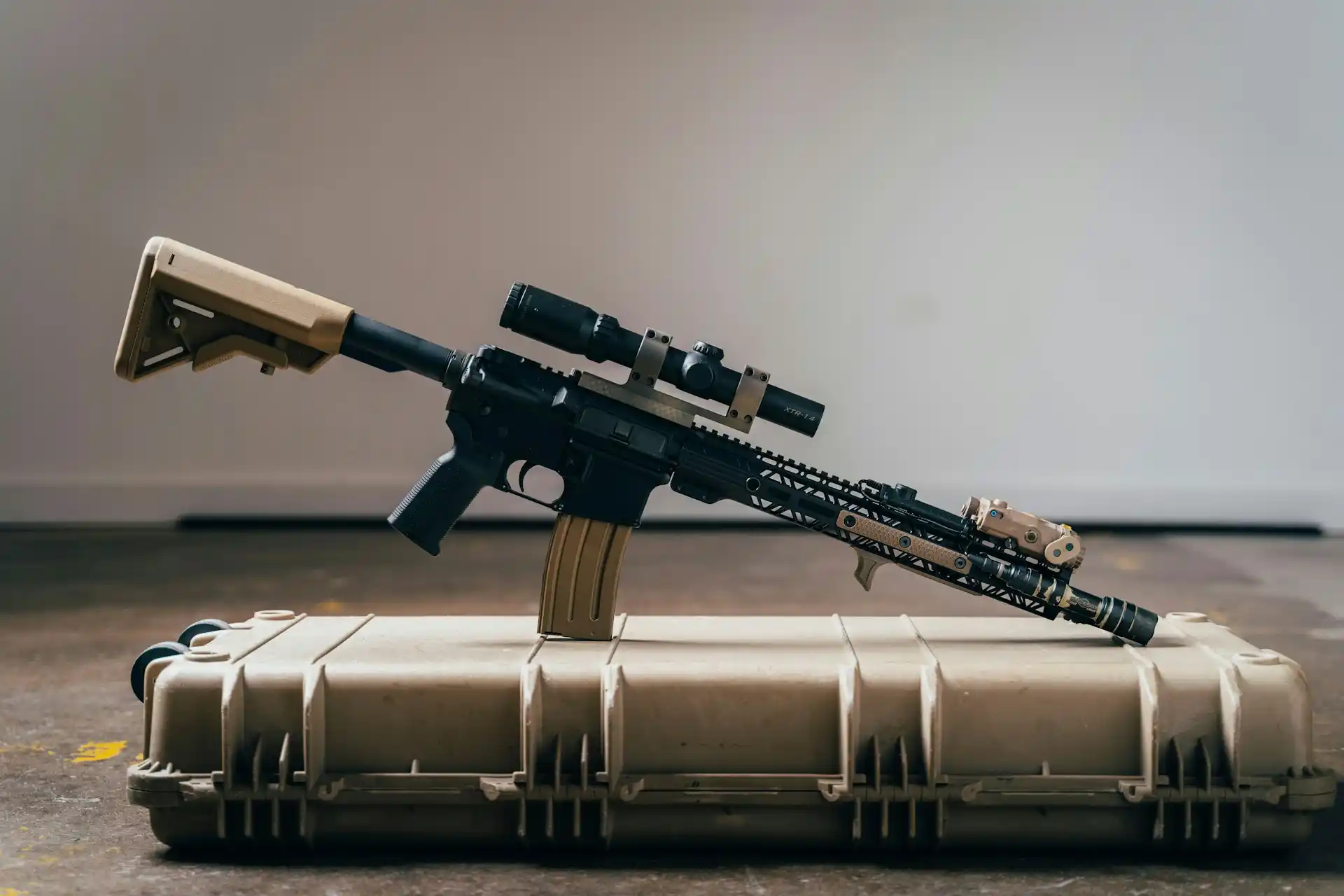 A semi-automatic rifle with a scope is placed on top of a hard plastic case, highlighting the ongoing discussions around bump stocks and potential bans.