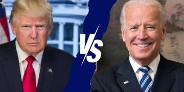 Split image of two men in suits with a "VS" in the middle. The man on the left has blond hair and a stern expression, while the man on the right has white hair and is smiling—capturing the essence of Biden vs. Trump debate rivalries.