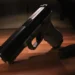 A black handgun lying on a wooden surface next to a detached magazine featured prominently in recent Caribbean crime news.
