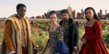 Four people dressed in Renaissance-era costumes stand outdoors, evoking scenes from *My Lady Jane*, with a historic building backdrop reminiscent of tales found on Prime Video.