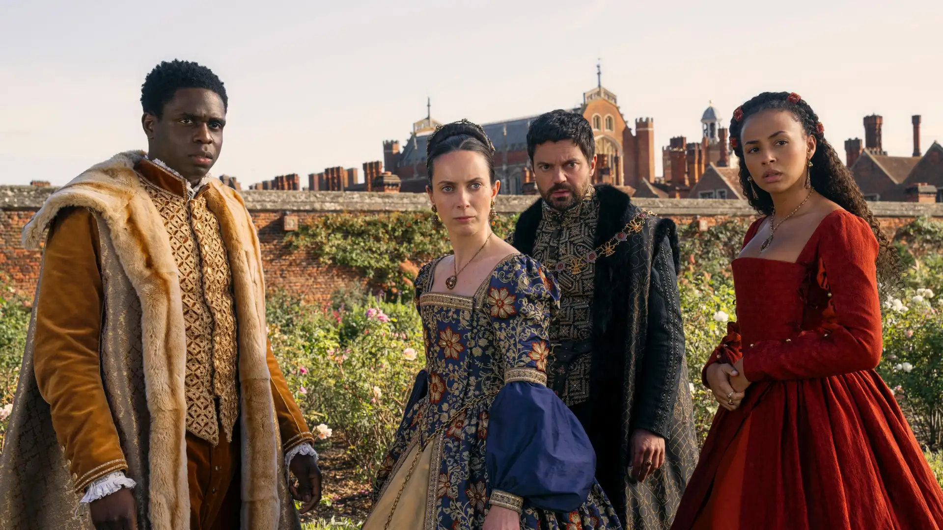 Four people dressed in Renaissance-era costumes stand outdoors, evoking scenes from *My Lady Jane*, with a historic building backdrop reminiscent of tales found on Prime Video.