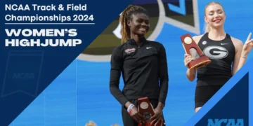 Rose Yeboah and Elena Kulichenko proudly hold their trophies on a blue podium at the NCAA Track & Field Championships 2024 Women's High Jump event.