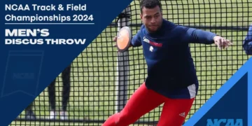 An athlete in a blue shirt and red pants readies to throw a discus in a netted area. Text reads, "NCAA Track & Field Championships 2024 Men's Discus Throw." Francois Prinsloo prepares to compete.