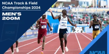 Athletes compete in the men's 200m race at the NCAA Track & Field Championships 2024, with Penn State's Cheickna Traore crossing the finish line first.