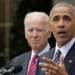 Barack Obama and Joe Biden in formal attire stand behind a podium outdoors. One is speaking into the microphone, while the other is looking on, reminiscent of an Obama-Biden debate moment.
