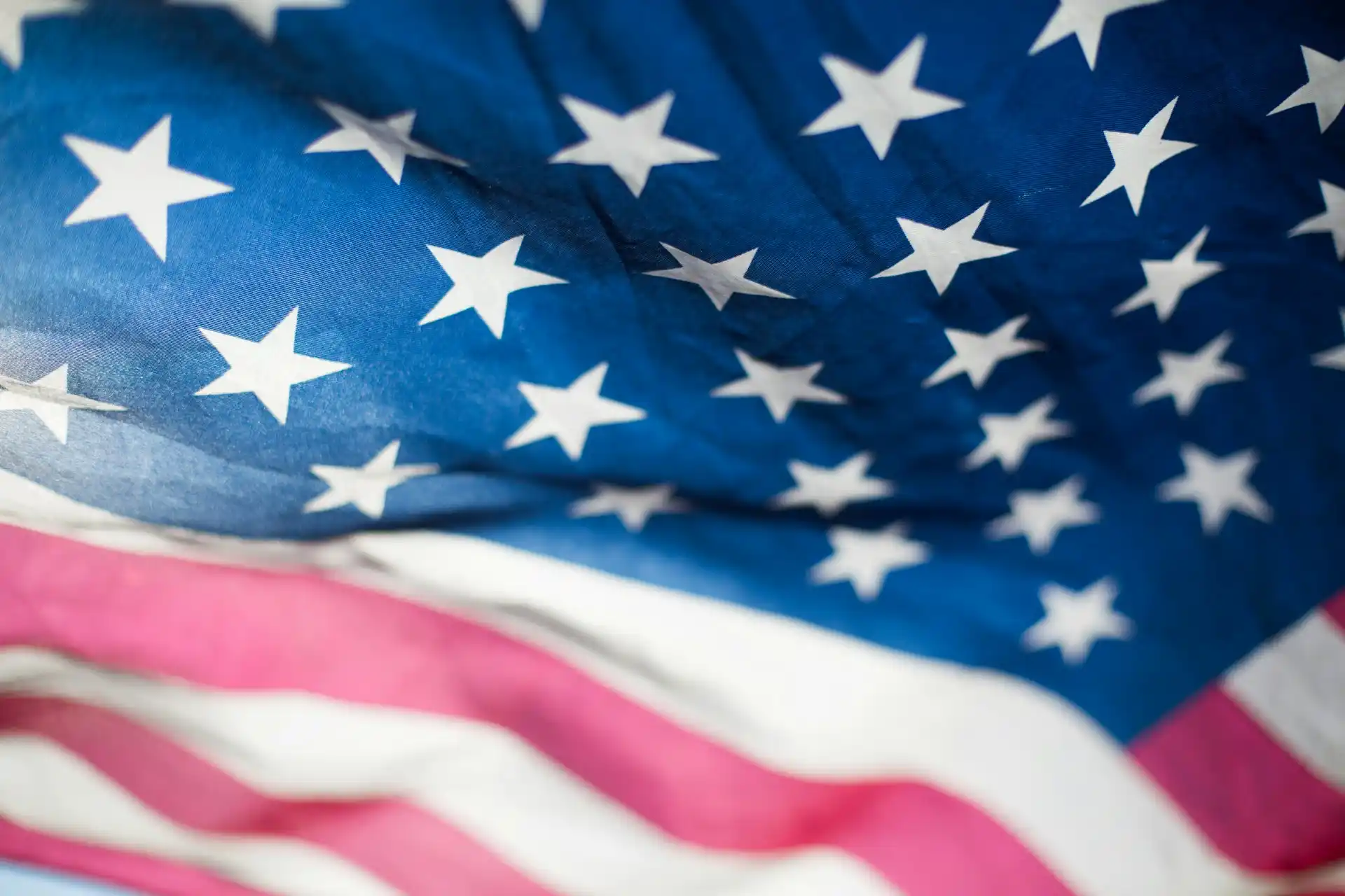 Close-up of the American flag showing the blue field with white stars and a portion of the red and white stripes, symbolizing unity as pivotal strategic initiatives take shape.