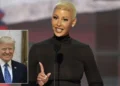 Amber-Rose with a shaved head, resembling Amber Rose, is speaking at a podium. There is a small inset image of another person in a suit and tie in the bottom left corner, reminiscent of the Republican National Convention setup.