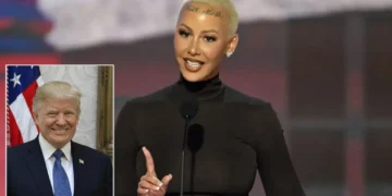 Amber-Rose with a shaved head, resembling Amber Rose, is speaking at a podium. There is a small inset image of another person in a suit and tie in the bottom left corner, reminiscent of the Republican National Convention setup.