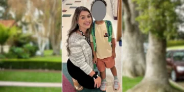 A woman kneels next to a child with a greyed-out face, both smiling in a school hallway. The child, presumably her son, wears colorful clothing and a backpack.