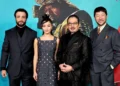 Four FX series Shogun cast members stand side by side in formal attire against a blue backdrop with a large image of a historical figure in the background, celebrating their Emmy nominations for the 2024 Emmys.