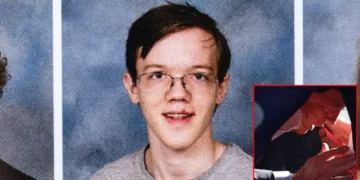 A 20-year-old Thomas Matthew Crooks. with glasses and a gray shirt is in a portrait-style photo. In the bottom right corner, there is a small image Former President Donald trump bleeding.