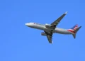 A United Airlines Boeing 757-200 shown in-flight against a clear blue sky, soaring smoothly on its route from Los Angeles to Denver.