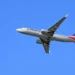 A United Airlines Boeing 757-200 shown in-flight against a clear blue sky, soaring smoothly on its route from Los Angeles to Denver.