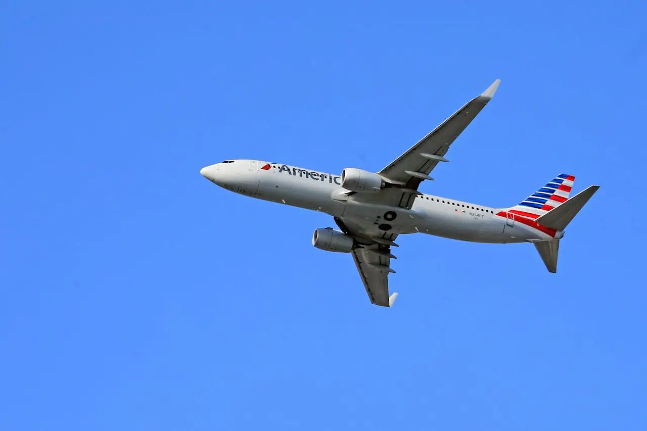 A United Airlines Boeing 757-200 shown in-flight against a clear blue sky, soaring smoothly on its route from Los Angeles to Denver.