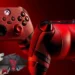 A close-up of two red and black gaming controllers with textured grips on a red background. The controllers have a comic book theme featuring Deadpool & Wolverine, with a small comic character depicted in the bottom left corner. Don’t miss your chance to enter the Xbox sweepstakes!
