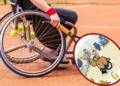 A person in a wheelchair holds a tennis racket on an outdoor court, reminiscent of the spirit of the Paris Paralympics 2024. Inset shows a cartoon bull on a tennis court holding a racket, echoing the vibrancy often seen in Google Doodle tributes.