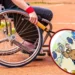 A person in a wheelchair holds a tennis racket on an outdoor court, reminiscent of the spirit of the Paris Paralympics 2024. Inset shows a cartoon bull on a tennis court holding a racket, echoing the vibrancy often seen in Google Doodle tributes.