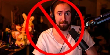 Amidst a backdrop of gaming gear, a figure with headphones and a microphone is crossed out by a red prohibition symbol, signaling Twitch's strict stance on hate speech policy enforcement.
