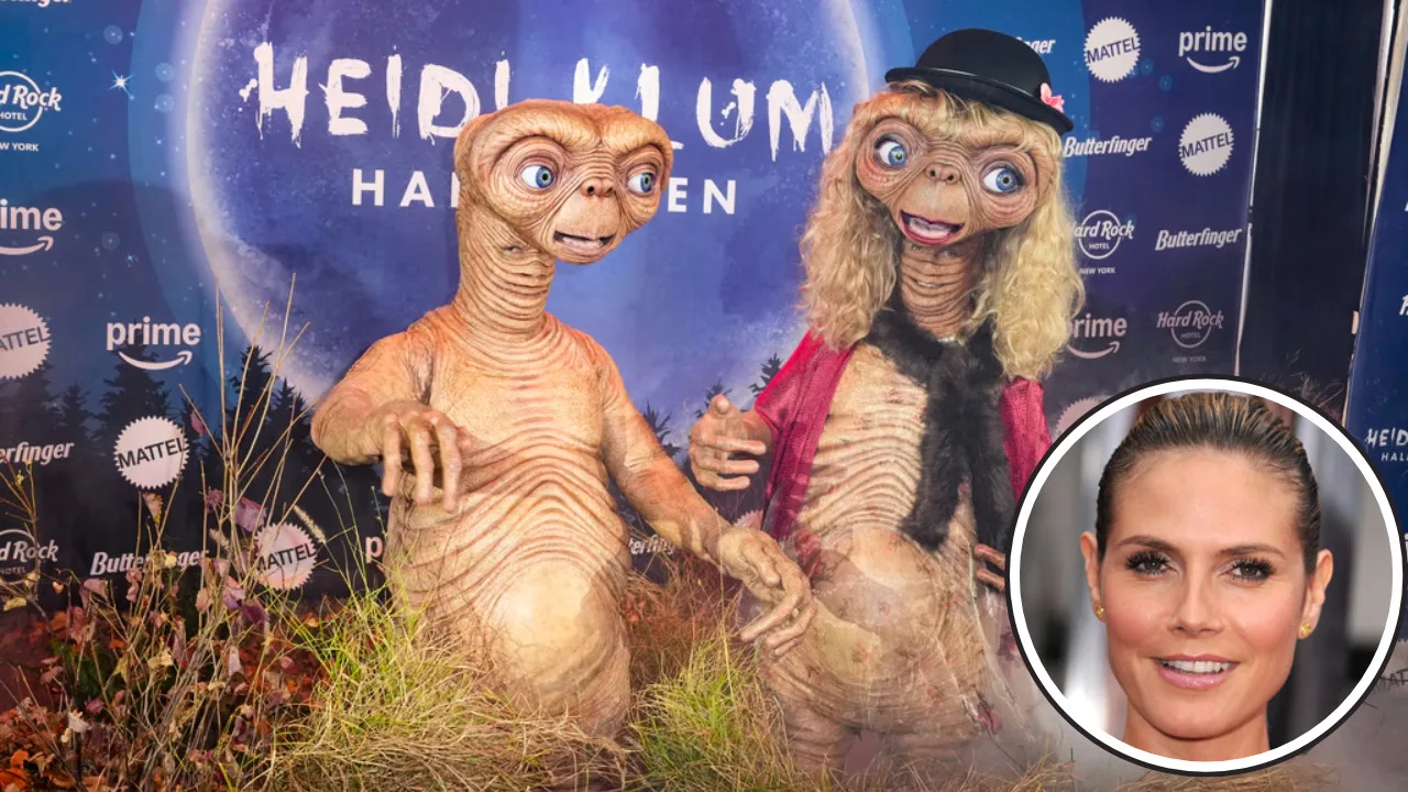 Two people dressed as E.T. characters at a costume event with a themed backdrop capture the spirit of Halloween costumes. Inset shows Heidi Klum's face, adding an extra touch of celebrity charm to the scene.