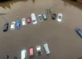 Aerial view of multiple cars partially submerged in floodwater in a parking lot, a result of the torrential rain sweeping through North-West England.